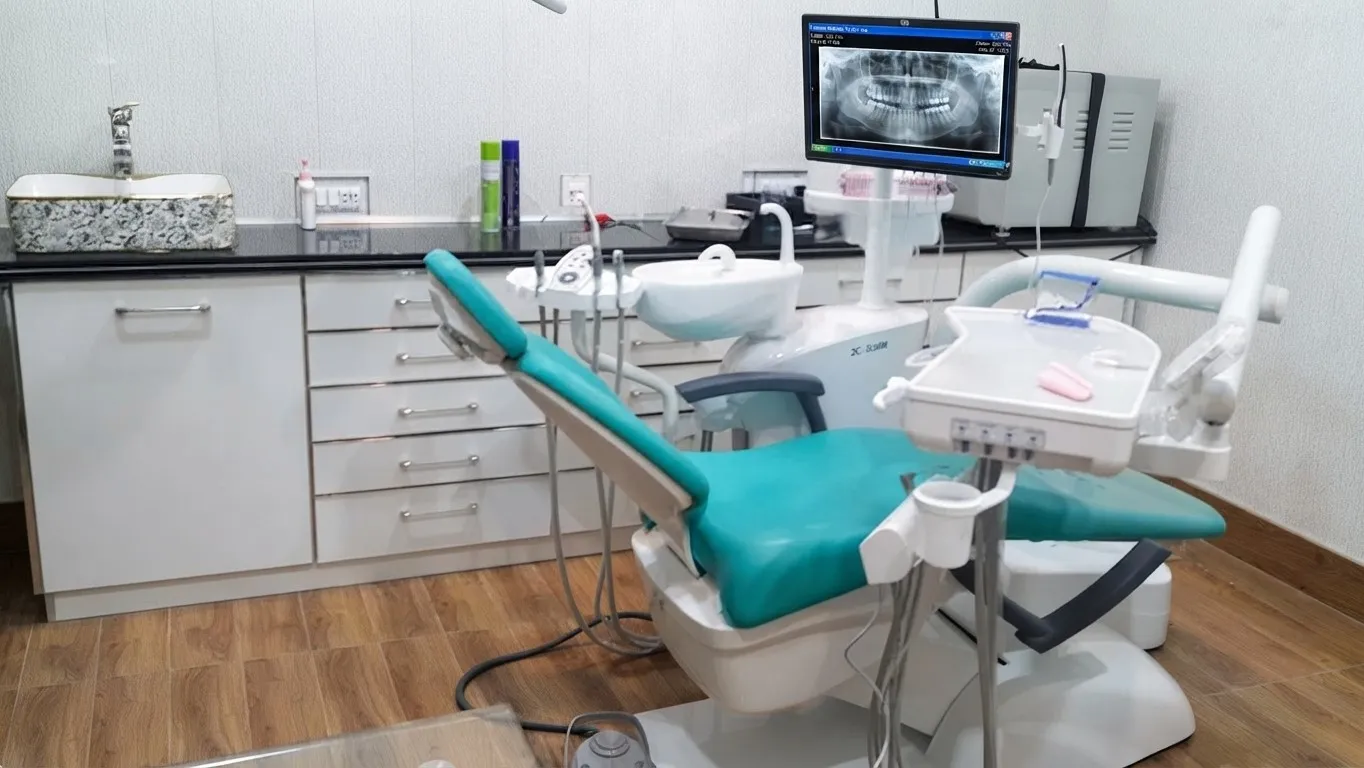 Clean, modern dental treatment room at Al-Rehman Dental Care with a dental chair, instruments and an X-ray display screen